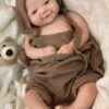 Realistic full body silicone baby doll Kent with open eyes, 19 inches long, lifelike skin and detailed features.