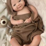 Realistic full body silicone baby doll Kent with open eyes, 19 inches long, lifelike skin and detailed features.
