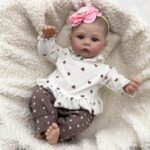 18-inch realistic newborn baby girl doll Mia with soft body, hand-painted features, and lifelike facial expression.