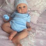 Full body silicone baby boy doll Benjamin with soft lifelike skin, realistic facial features, and flexible newborn body.