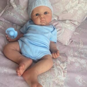 Full body silicone baby boy doll Benjamin with soft lifelike skin, realistic facial features, and flexible newborn body.