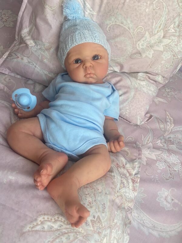 Full body silicone baby boy doll Benjamin with soft lifelike skin, realistic facial features, and flexible newborn body.