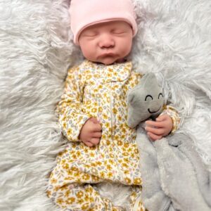 Full body silicone reborn baby boy doll Hudson sleeping in a blue outfit, showcasing the seamless silicone material.