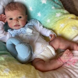 Realistic full silicone reborn baby boy doll Logan with soft skin, flexible body, and hand-painted lifelike features.
