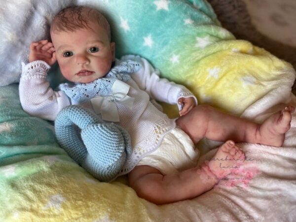 Realistic full silicone reborn baby boy doll Logan with soft skin, flexible body, and hand-painted lifelike features.