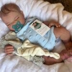Realistic full silicone reborn baby girl doll Olivia with soft skin, hand-painted details, and lifelike facial expression. Silicone baby dolls