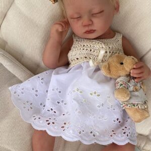 Realistic platinum silicone reborn doll Ella posed in a white blanket.