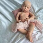 Realistic full-body silicone baby boy doll Michael sleeping peacefully.