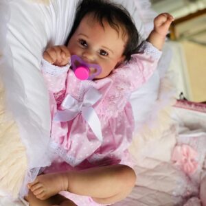 Realistic reborn toddler baby girl doll Maddie standing, with long rooted hair and open eyes.