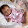 Realistic reborn toddler baby girl doll Maddie standing, with long rooted hair and open eyes.