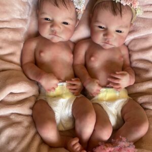 Ultra-realistic full body silicone twin baby dolls, Daisy and Riley, awake and smiling.